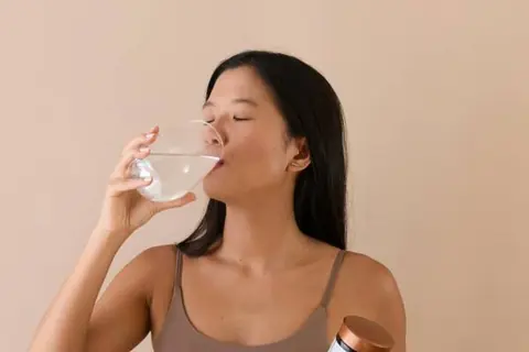 mounjaro interactions | woman taking medication with water