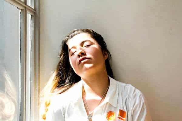 How to Combat Mounjaro Fatigue | Young woman resting with sun through window
