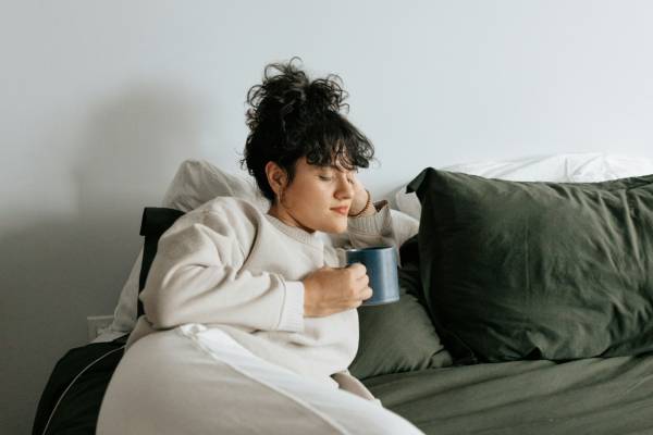 mounjaro side effects | woman lying on sofa