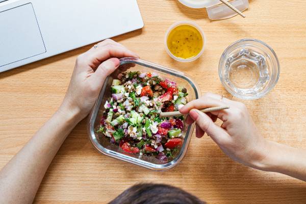 fibremaxxing on glp-1s | person eating salad at desk with laptop