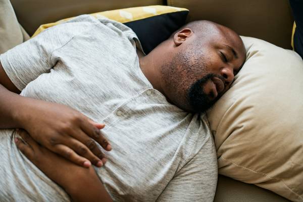 Does Wegovy Make You Tired? | Man in grey t shirt sleeping on pillow