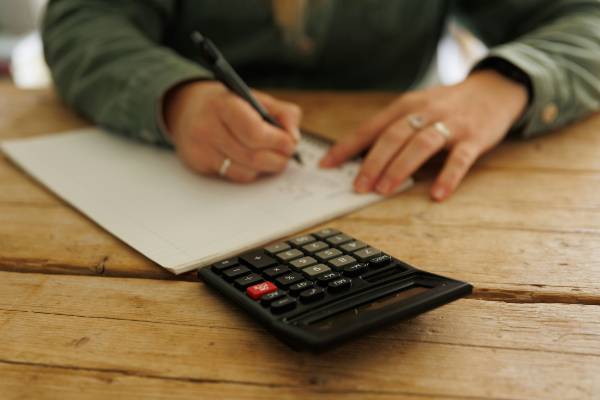 what are my options if i can't afford mounjaro ? | woman's arms on table with calculator making notes
