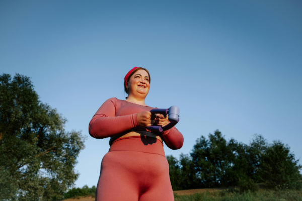 how to prevent muscle loss as you lose weight | woman in pink leggings and top outside exercising