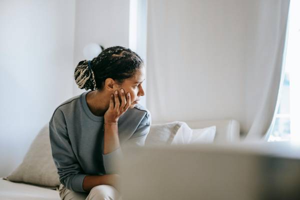 wegovy 7.2 mg side effects | woman on sofa with head in hand